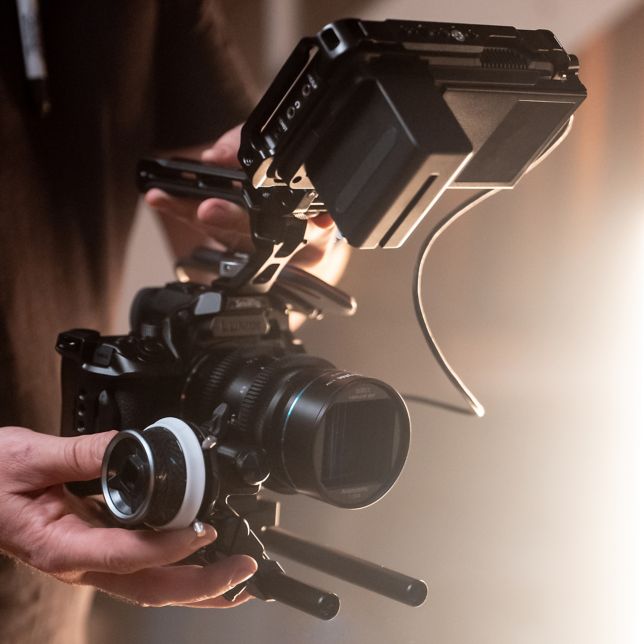 A content creator filming a video with the LUMIX S5IIX