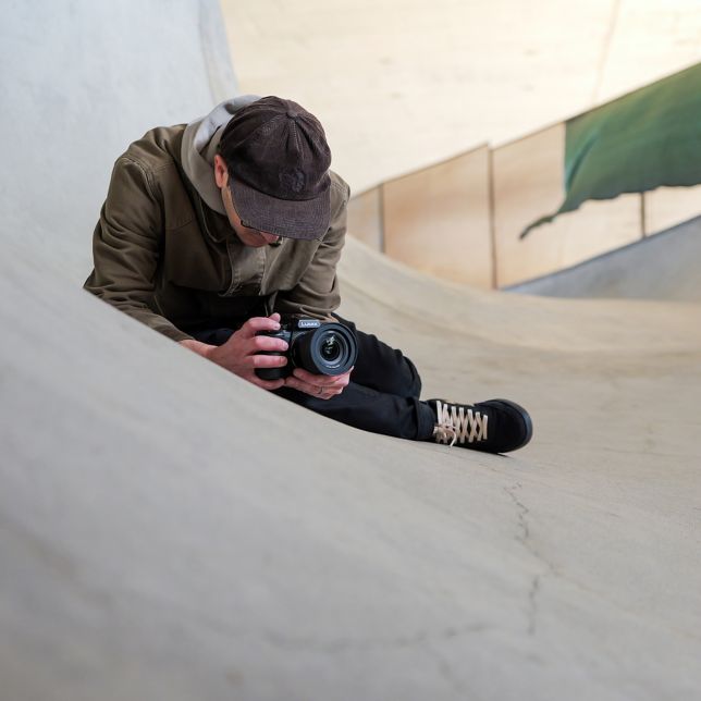 A content creator shooting handheld with the LUMIX S1II