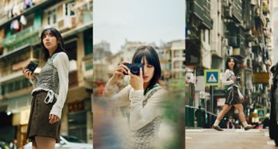 Photographer moving through the streets with the premium compact camera LUMIX L10 (DC-L10)